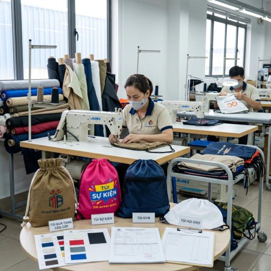 Xưởng may túi dây rút Mi A với quy trình sản xuất trực tiếp, kiểm mẫu và kiểm tra chất lượng sản phẩm.